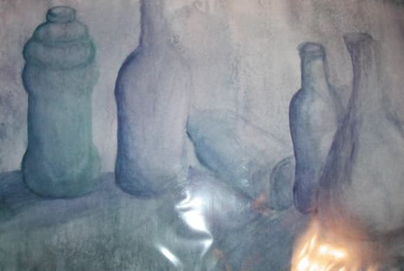 A blue-green still life of upright bottles and a tipped vessel, photographed with visible reflections near the bottom.