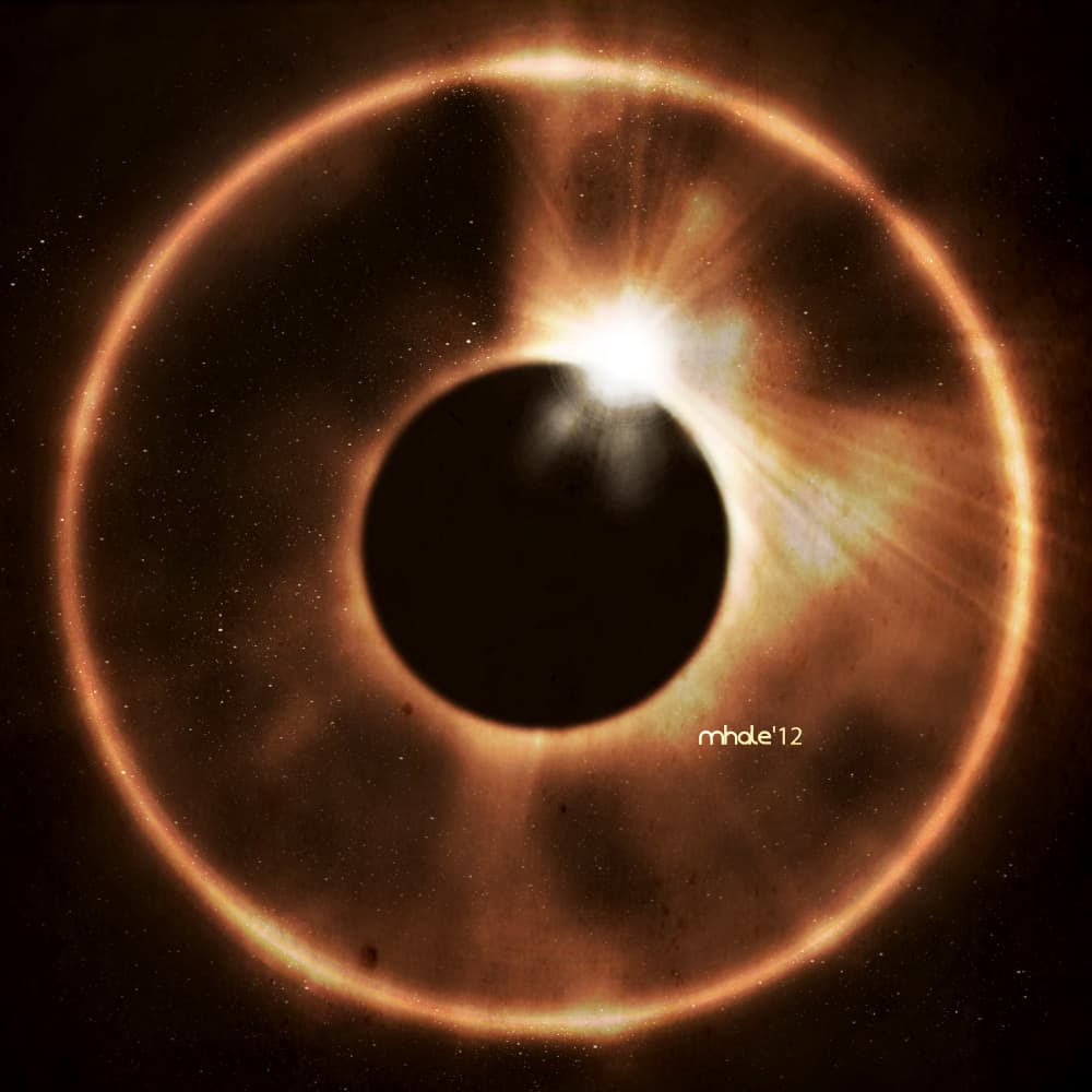 A dark planet crosses a brilliant golden flare surrounded by a circular halo.