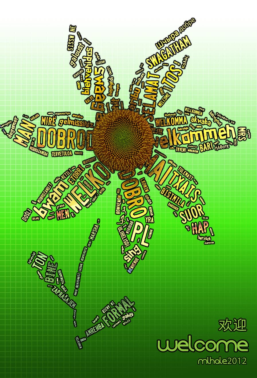 Multilingual welcome greetings form sunflower petals around a seed head on a green grid.
